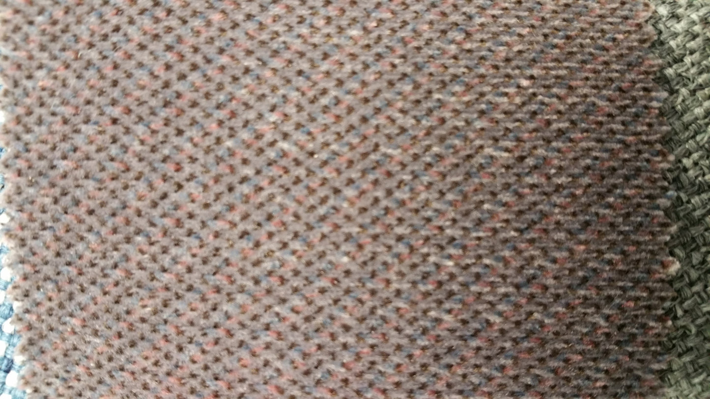 Ring 861 Contract Fabric: Close-up of textured brown fabric with hints of blue and pink threads.
