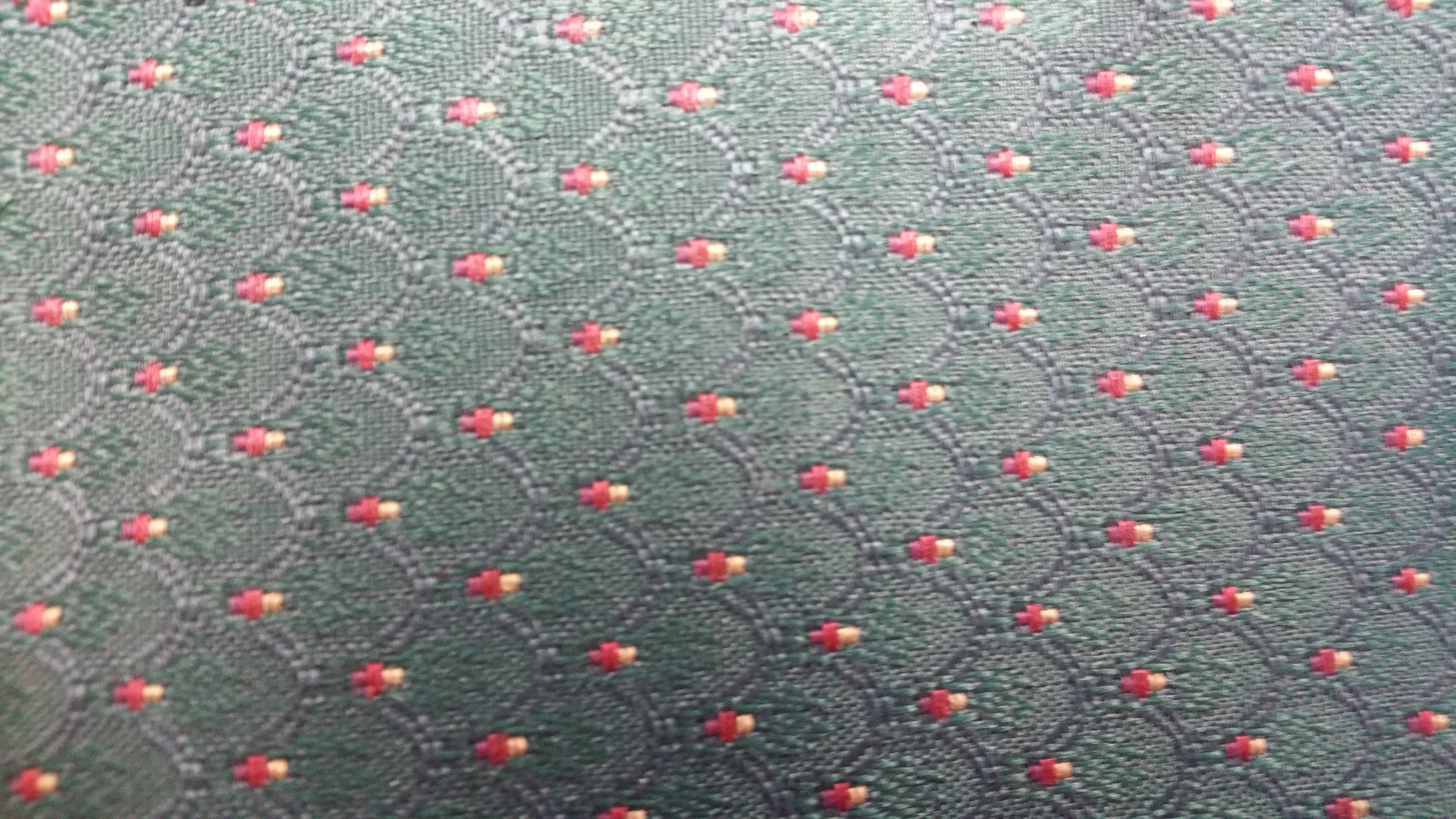 Ring 1106 Chatham Pattern Fabric: Dark green woven fabric with repeating red and gold diamond pattern.