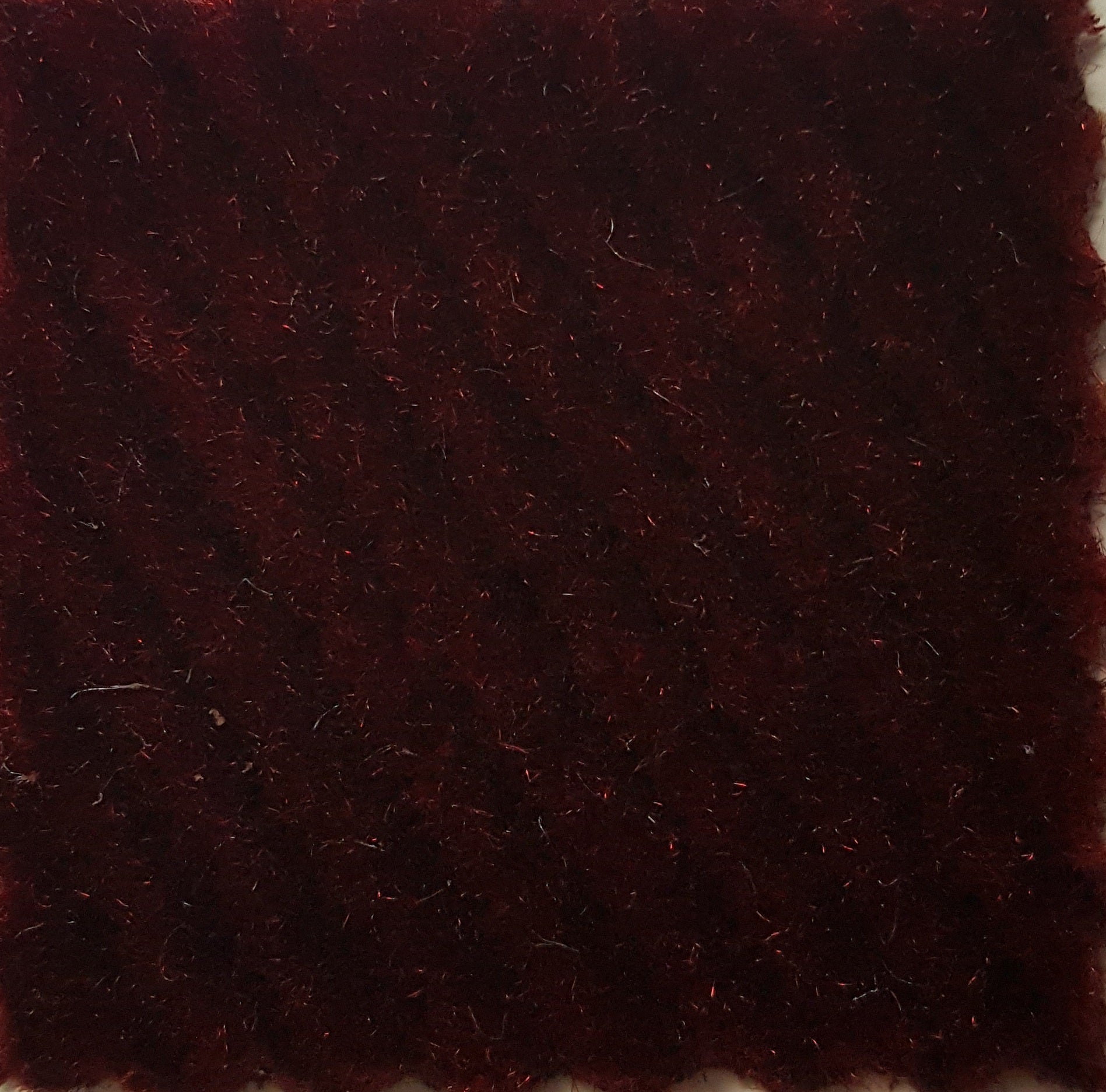 Madera Brick sample: Deep red, textured fabric swatch.