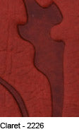 Close-up of rich claret-colored premium leather with embossed detailing.