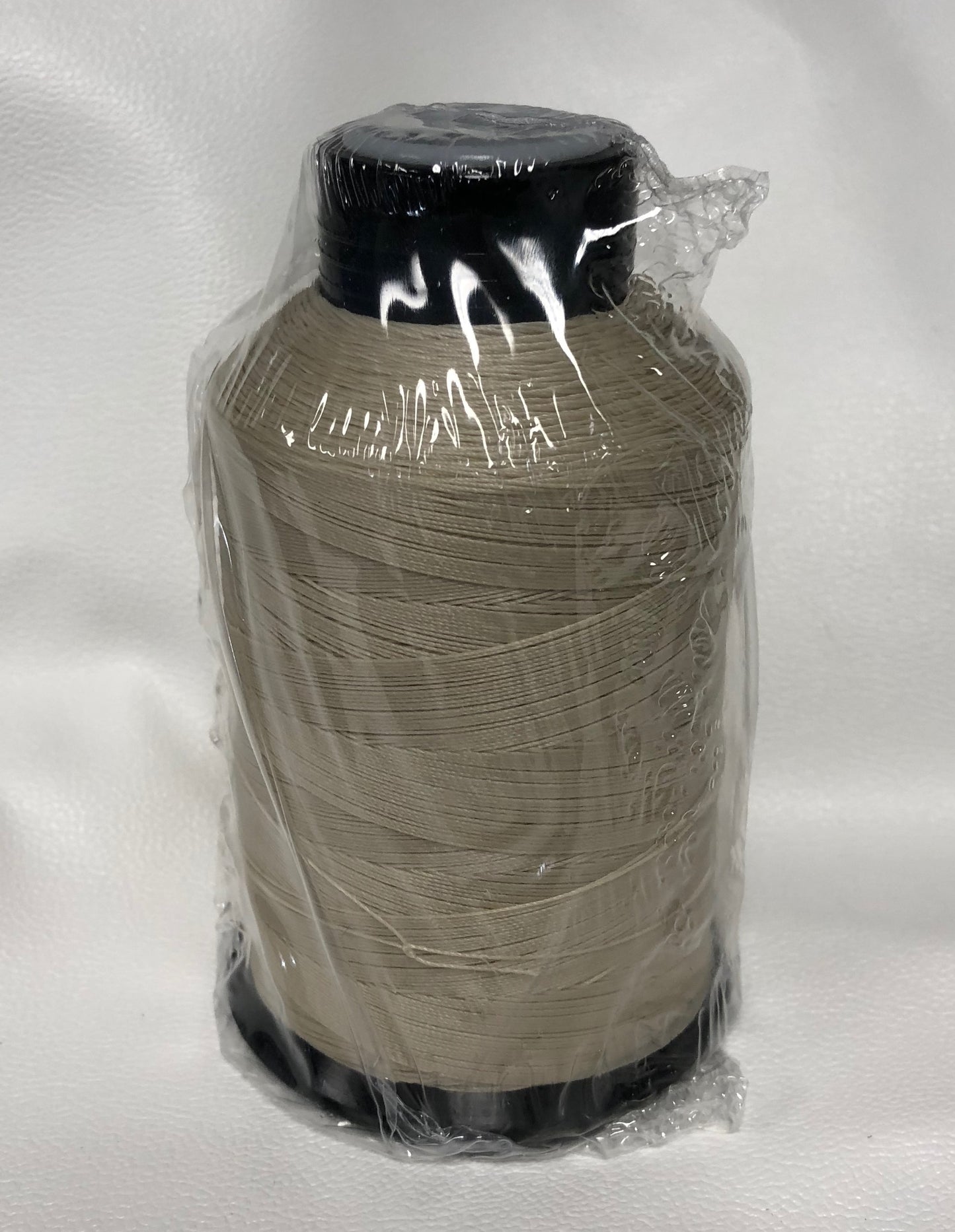 Sunguard B92 Parchment 239Q 4oz thread spool, light beige, plastic wrapped.