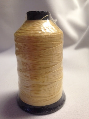 T-270 Nylon 701Q Natural Contrast Thread: Pale yellow spool of nylon thread, ideal for sewing and crafting projects.