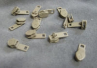 Beige zipper slides: 12 pack of small, lightweight metal zipper pulls for clothing repair or crafting.