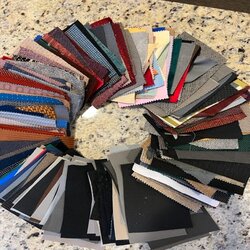 Fabric sample ring showcasing diverse upholstery textures and colors for interior design projects.