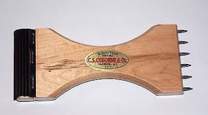 C.S. Osborne Webbing Stretcher: Wooden tool with metal teeth for stretching webbing.