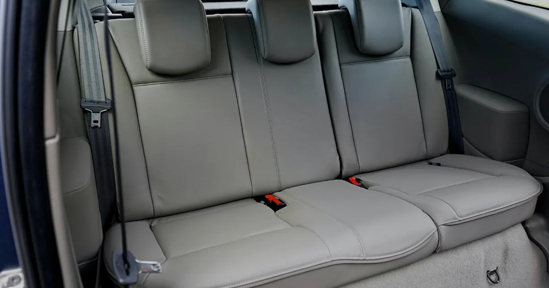 Light gray leather-look rear car seats in a vehicle interior