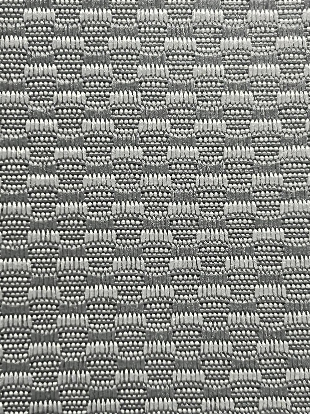 Close-up of gray automotive loop carpet showing the woven pile texture at Midwest Fabrics