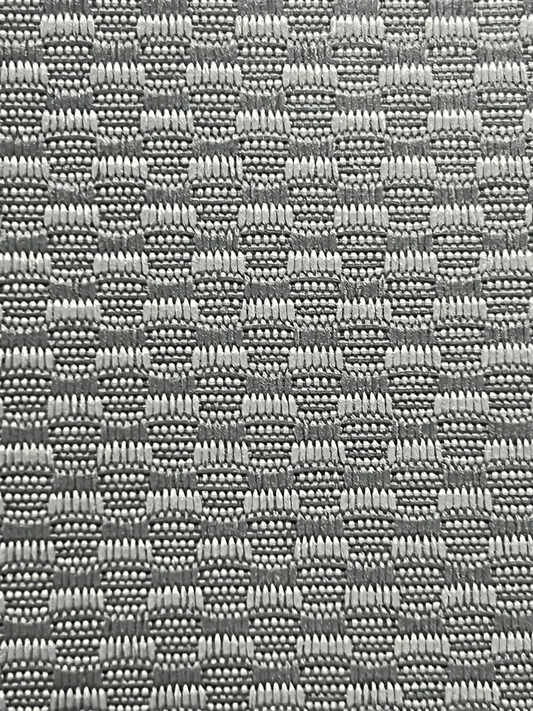Close-up of gray automotive loop carpet showing the woven pile texture at Midwest Fabrics