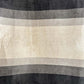 Beige and black striped upholstery fabric swatch.