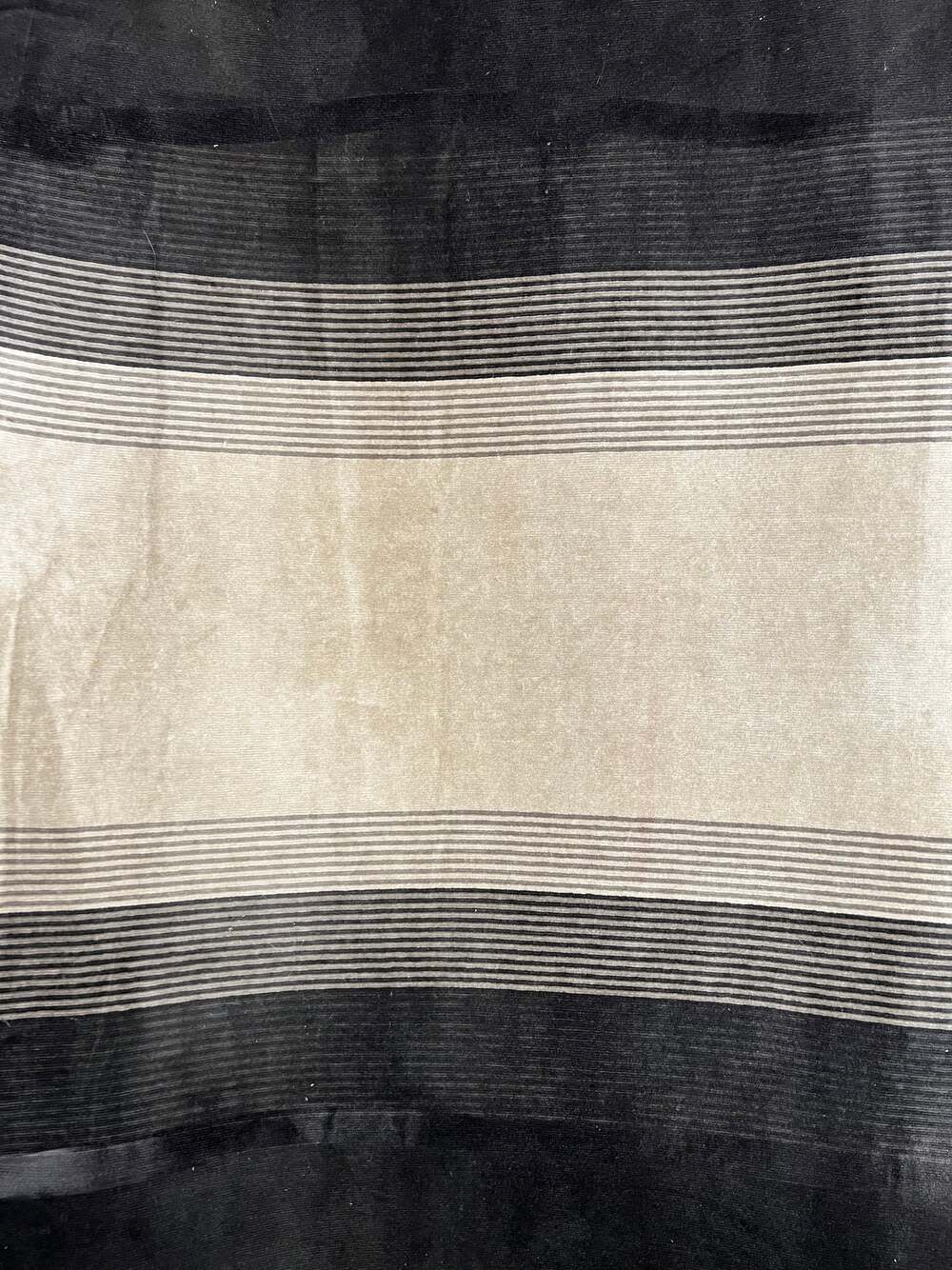 Beige and black striped upholstery fabric swatch.
