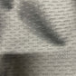 Close-up of gray patterned upholstery fabric sample.