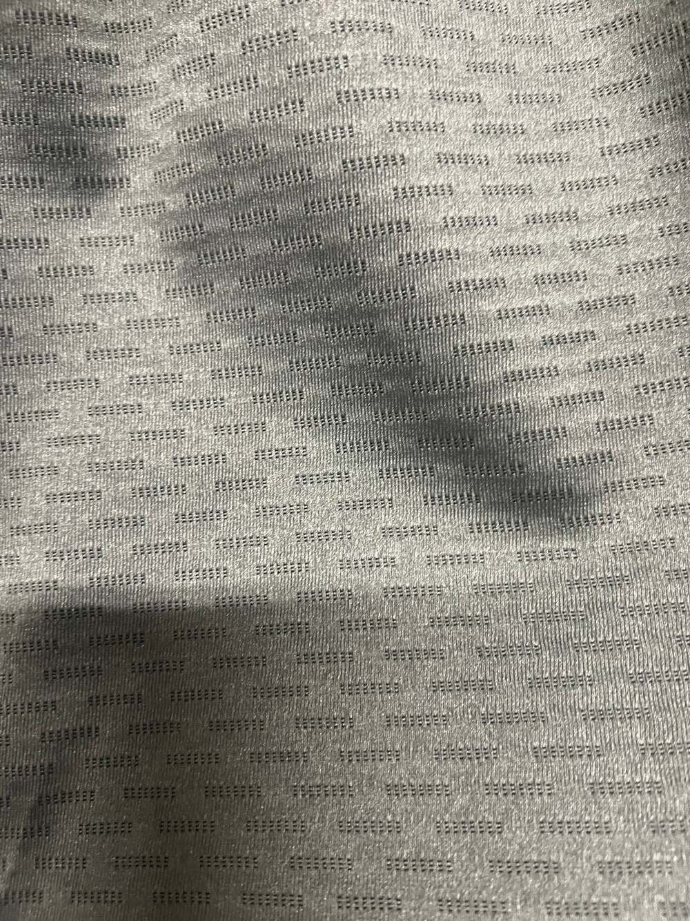 Close-up of gray patterned upholstery fabric sample.