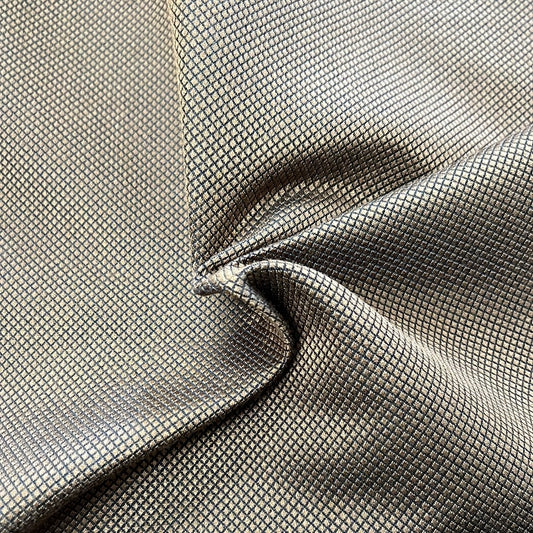 Funtutti Choco fabric: Gold and black geometric pattern, luxurious textured upholstery material.
