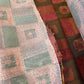 Burgundy and gray patterned upholstery fabric swatches.