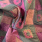 Burgundy patterned fabric swatch, close-up showing textured weave and color details.