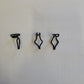 Black plastic clips against a white background.
