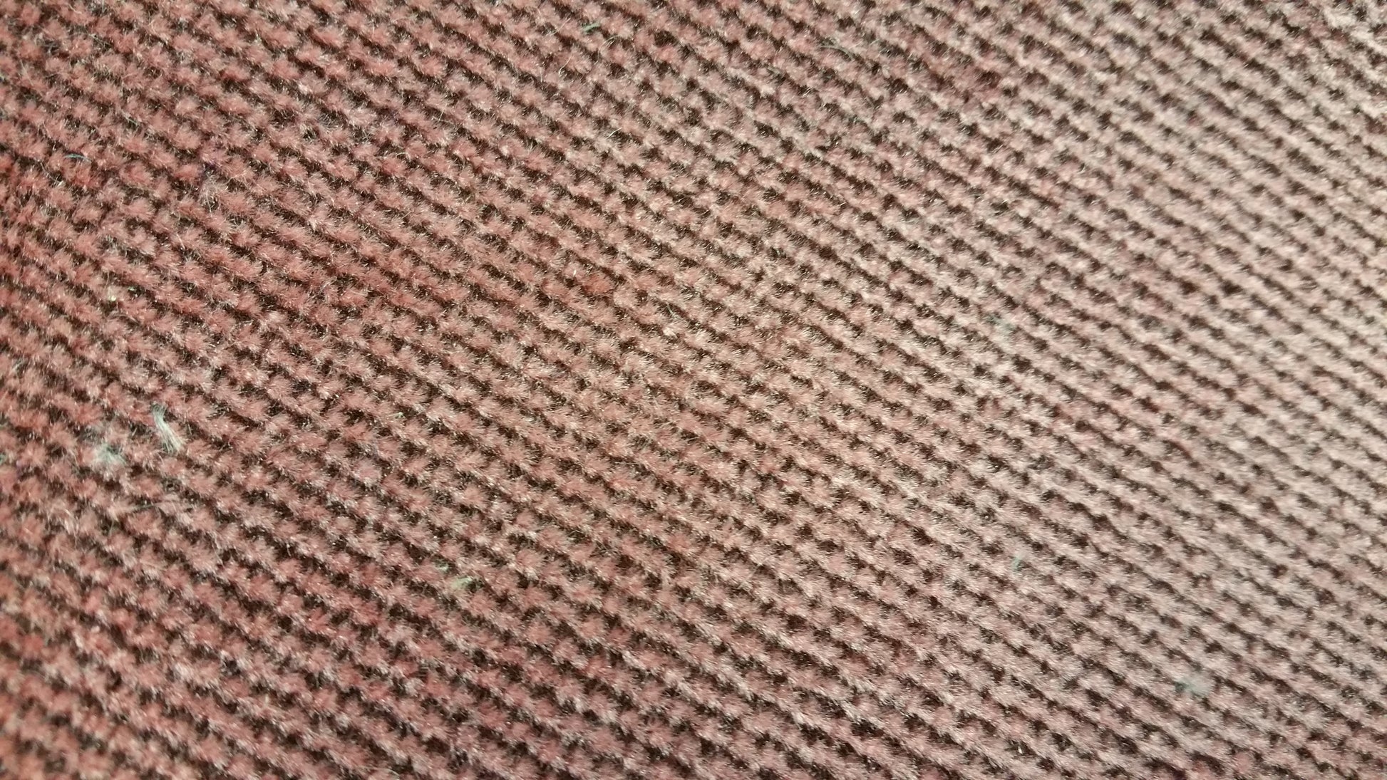 Ring 1014 Conversion Van Fabric: Close-up of textured maroon fabric with diagonal pattern.
