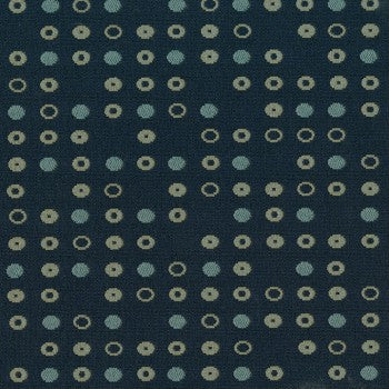 Culp Fine Tune Indigo fabric swatch: dark blue background with repeating pattern of teal and beige circles.

