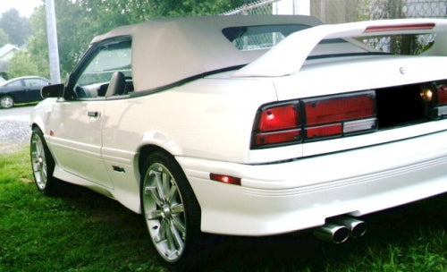 White 1991-94 Chevrolet Cavalier convertible with dark tan top, rear view
